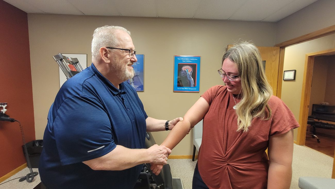 Dr. Badinger and a patient shaking hands on her plan