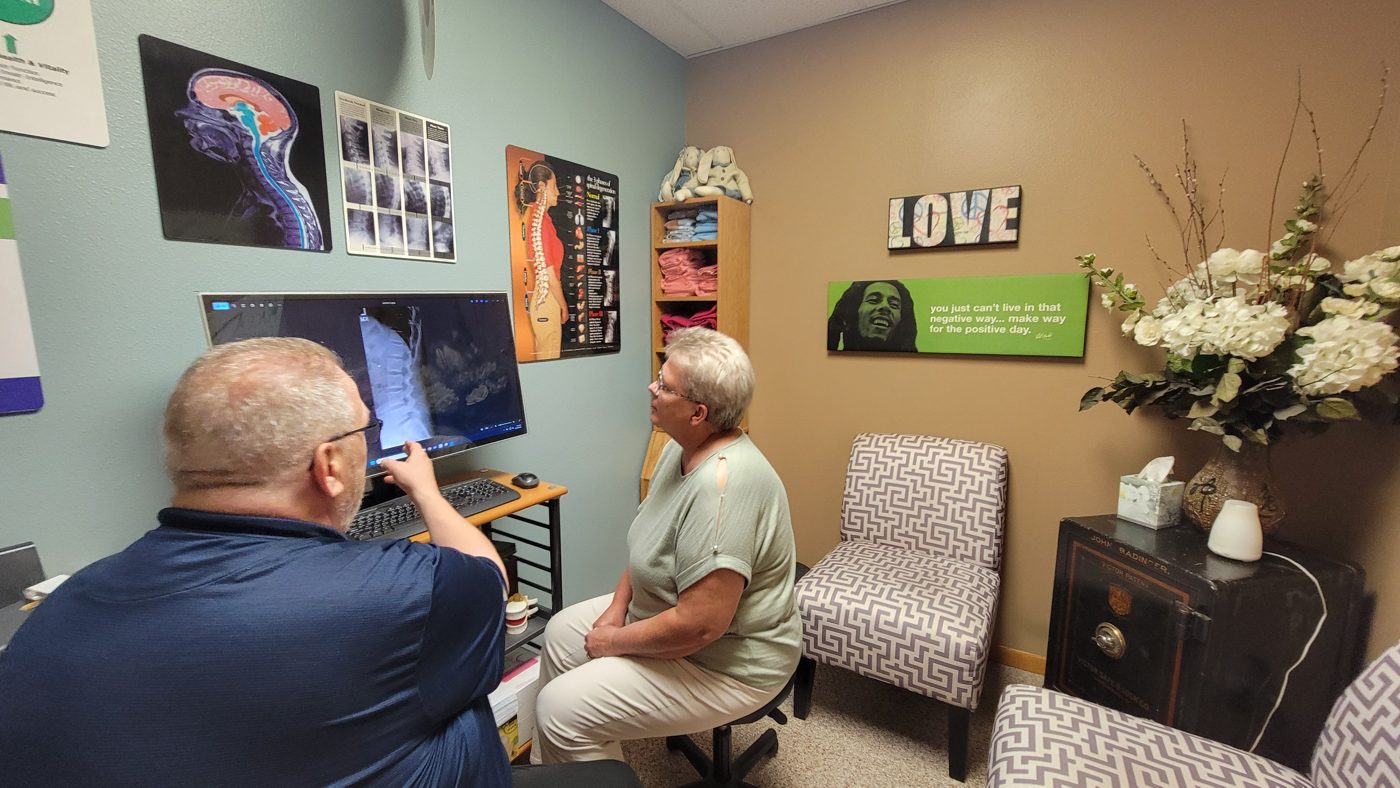 Dr. Badinger reviewing spinal images with a patient