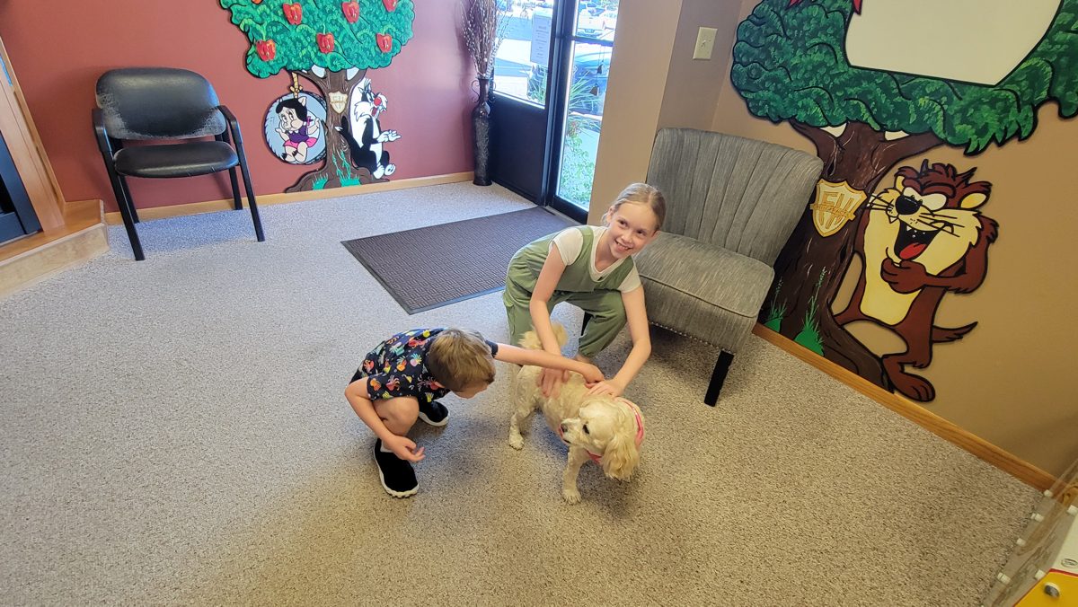 A young visitor saying hello to Lexi in the waiting room