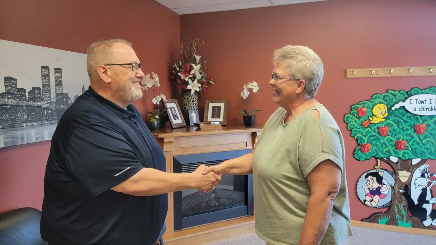 Dr. Badinger welcoming a patient at Family Health Chiropractic